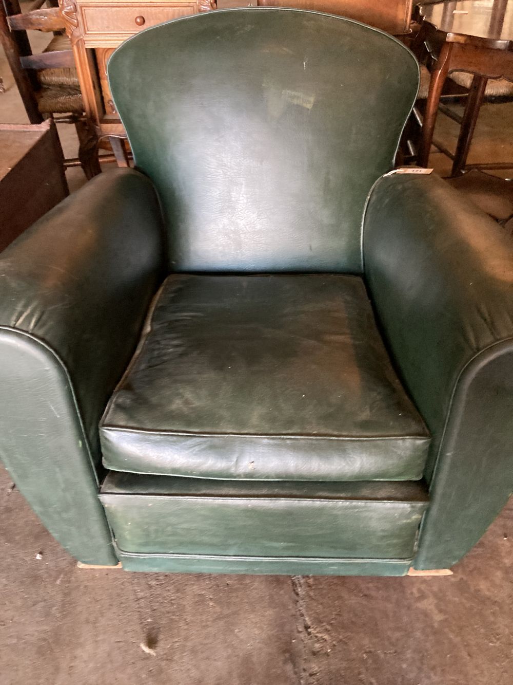 An Art Deco green leatherette armchair